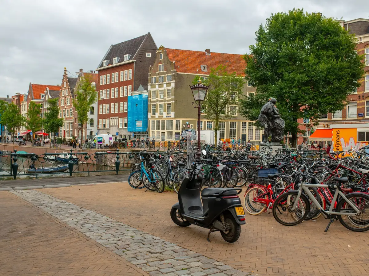 Rows of parked bicycles on a canal square in Amsterdam