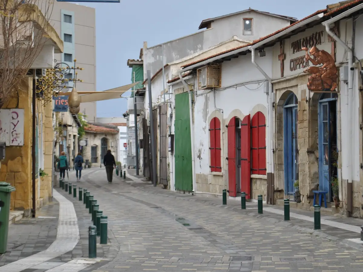 A quiet old-town street in Cyprus with coloured shutters