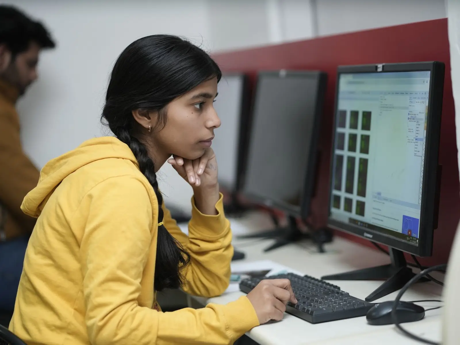 A student studying a dashboard on a computer in a university lab