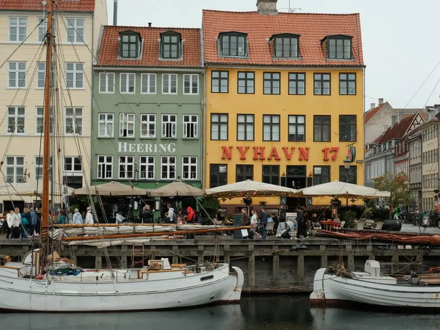 Colourful houses and boats along Nyhavn canal in Copenhagen
