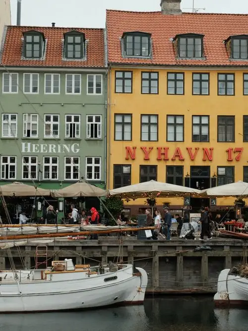 Colourful houses and boats along Nyhavn canal in Copenhagen