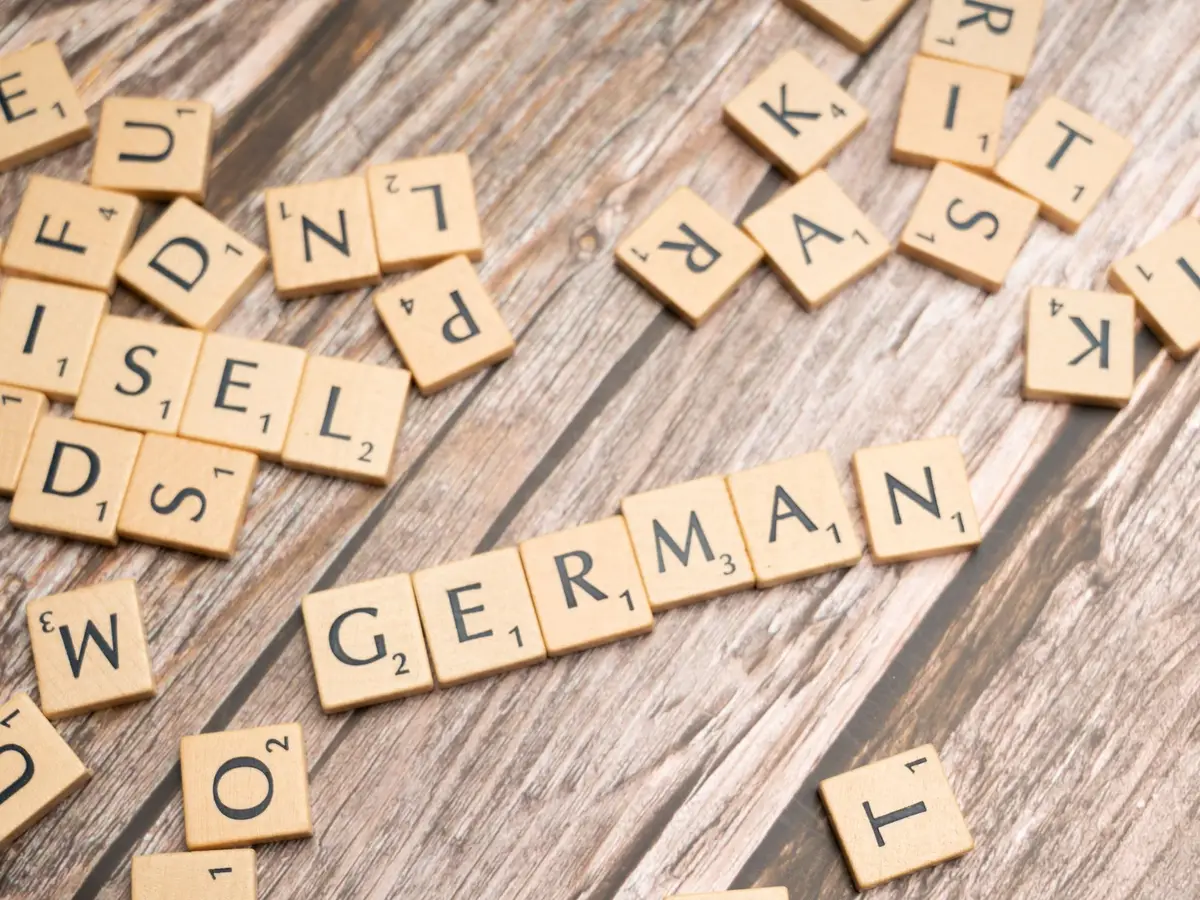 Wooden letter tiles spelling the word German on a table