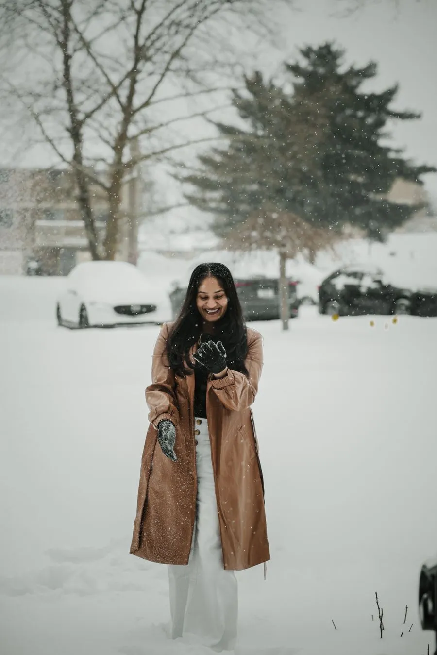 Rojina smiling in a winter coat as snow falls in Finland