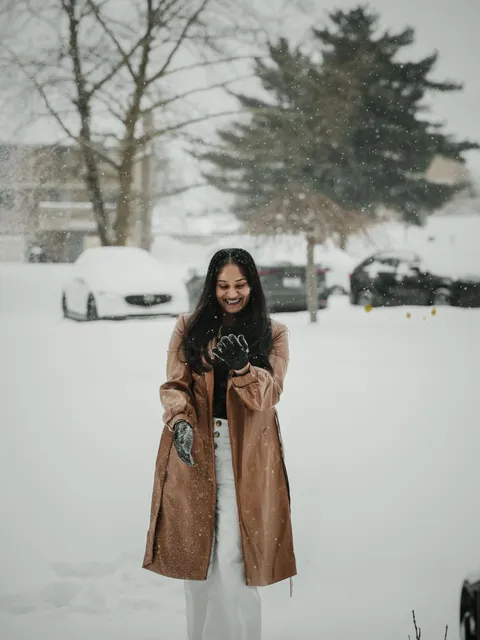 A student smiling in the falling snow in Finland