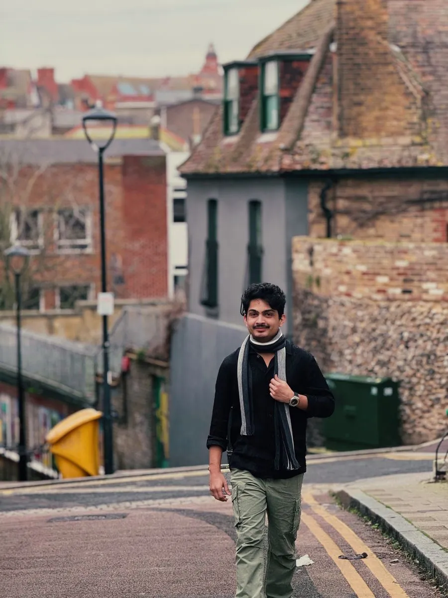 Aayush walking down an old-town street in Germany