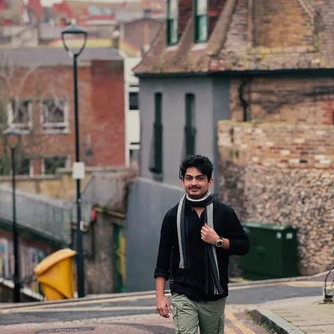 A student walking down an old town street in Germany