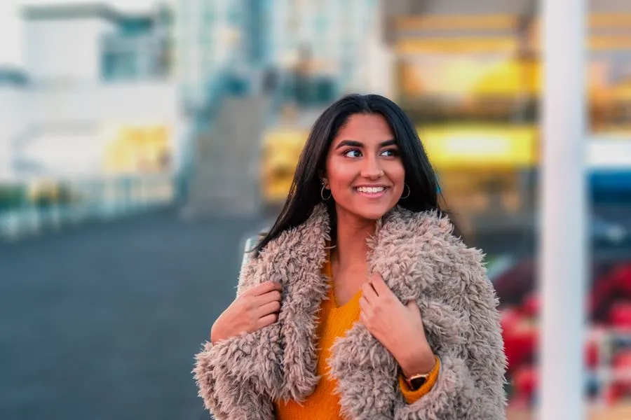 Ishita smiling in a winter coat in the city