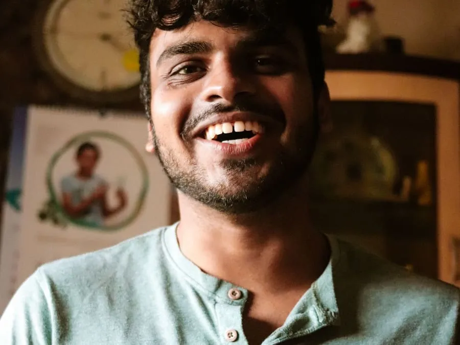 Sagar laughing in a green t-shirt